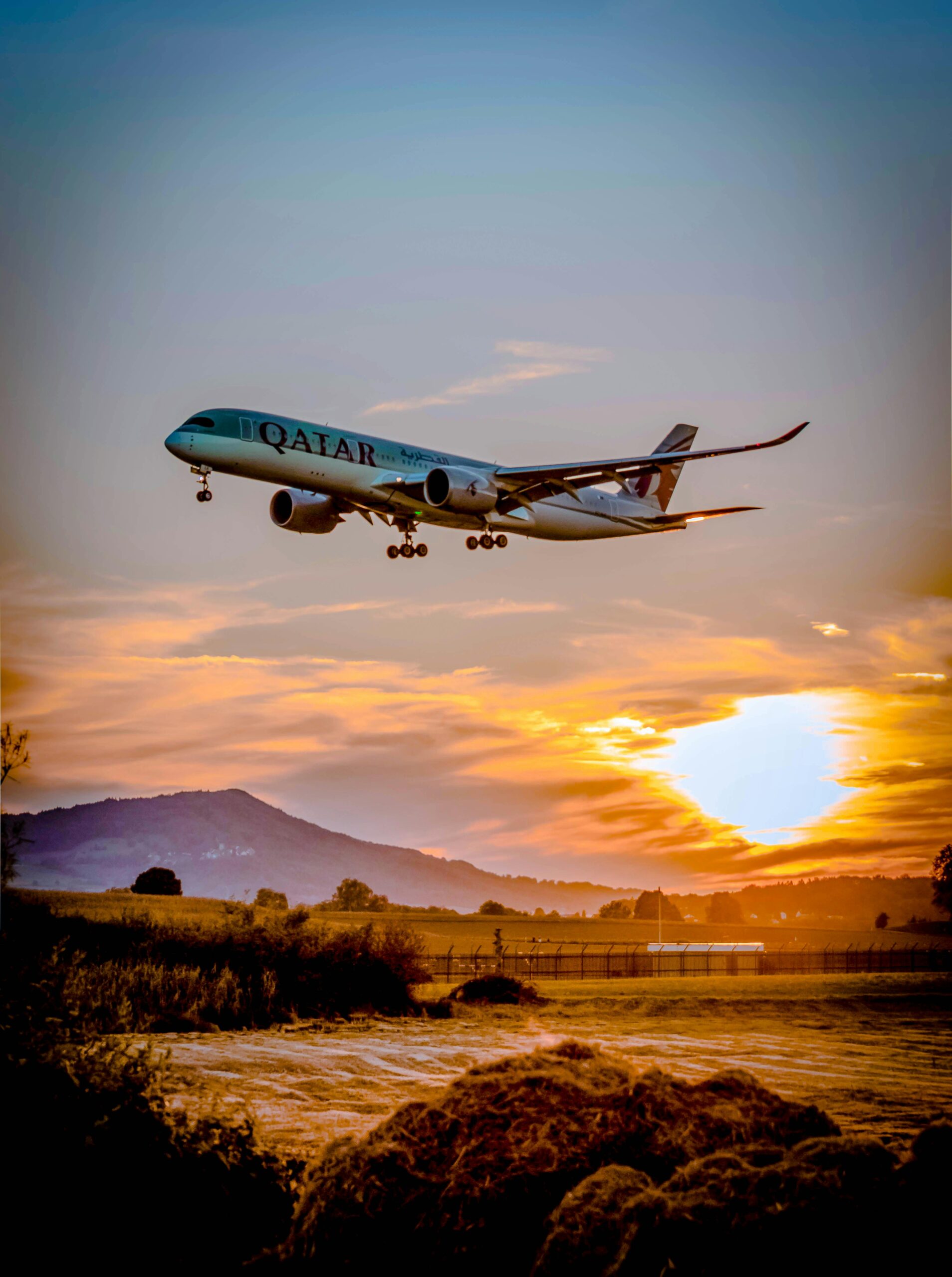 A passenger airplane flying over a scenic landscape at sunset, capturing the aviation spirit.