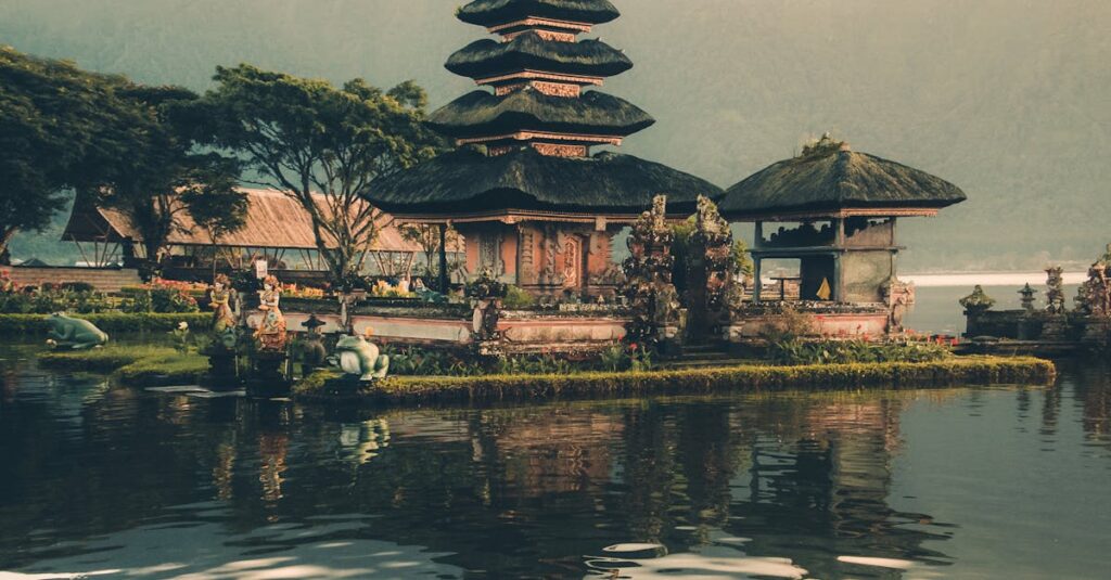A serene view of Ulun Danu Beratan Temple with reflections on the water at sunrise, Bali.